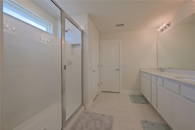 bathroom with an enclosed shower, double vanity, and tile flooring