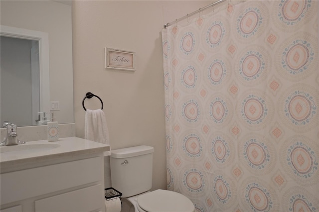 bathroom featuring toilet and large vanity