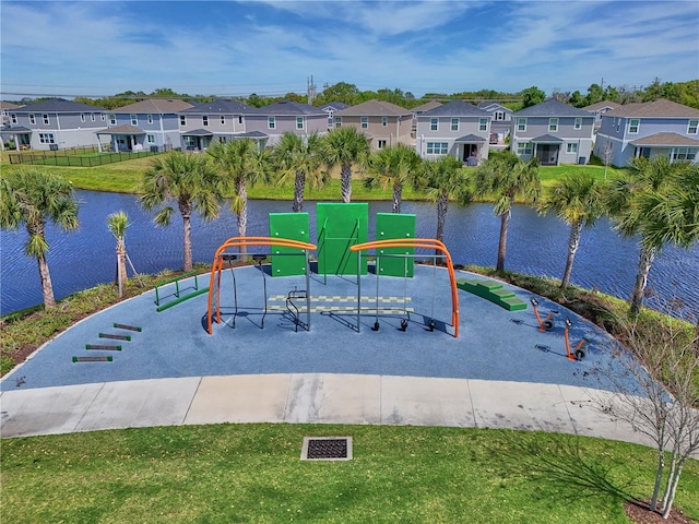 view of playground featuring a water view and a yard