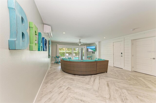 interior space with ceiling fan, parquet floors, and a wall unit AC