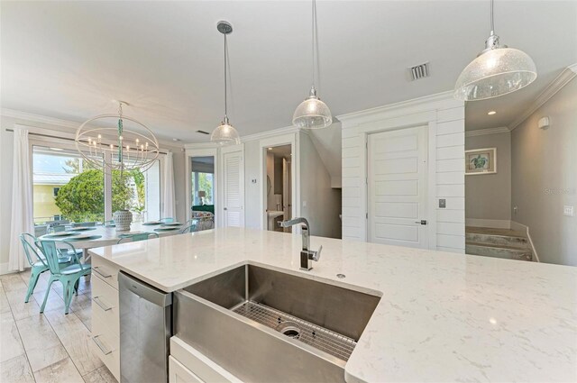 kitchen featuring hanging light fixtures, light stone countertops, crown molding, and stainless steel dishwasher