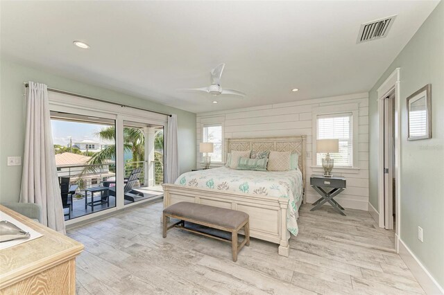 bedroom with light hardwood / wood-style flooring, ceiling fan, and access to exterior