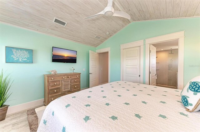 bedroom with wood ceiling, lofted ceiling, ceiling fan, and connected bathroom