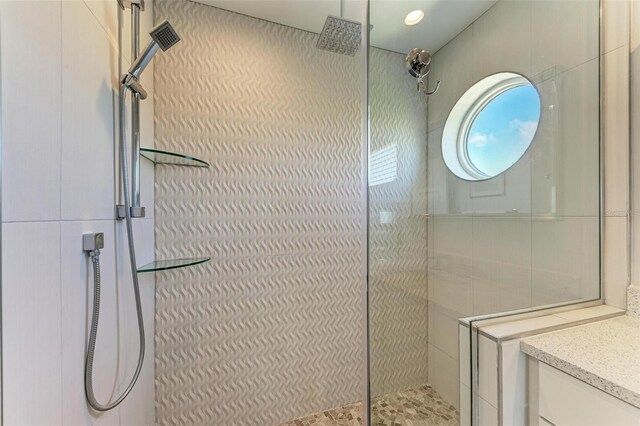 bathroom with an enclosed shower and vanity