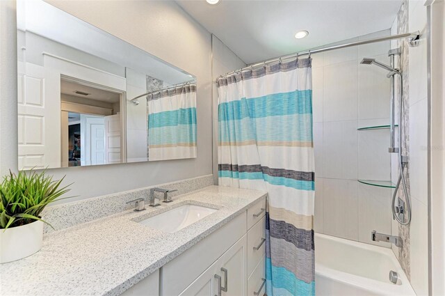 bathroom featuring shower / bath combo and large vanity