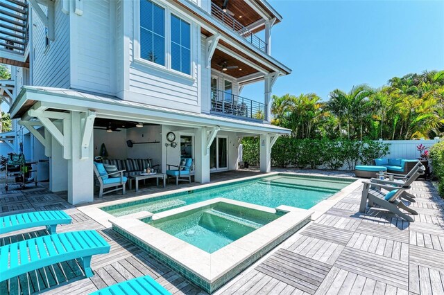 view of pool featuring a patio area, ceiling fan, and an in ground hot tub