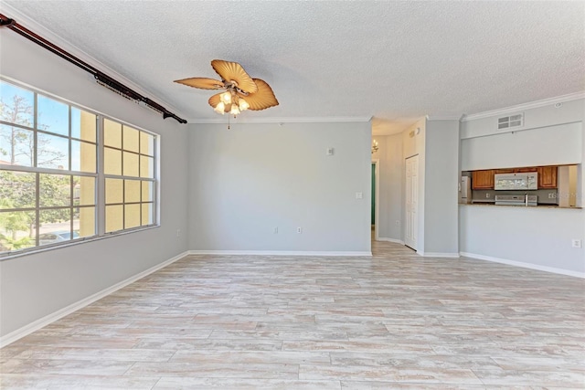 unfurnished living room featuring plenty of natural light, ceiling fan, and crown molding