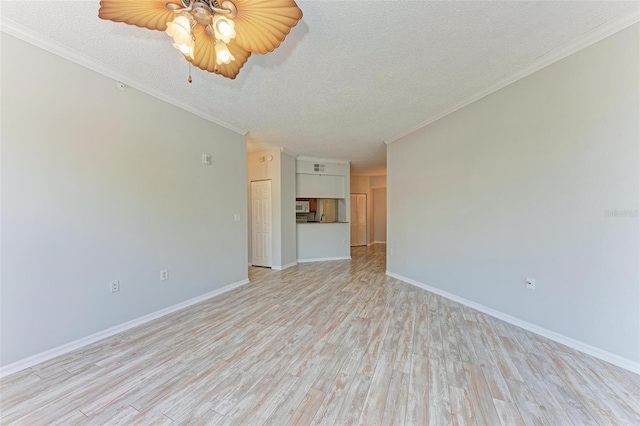 unfurnished room featuring crown molding, ceiling fan, a textured ceiling, and light wood-type flooring