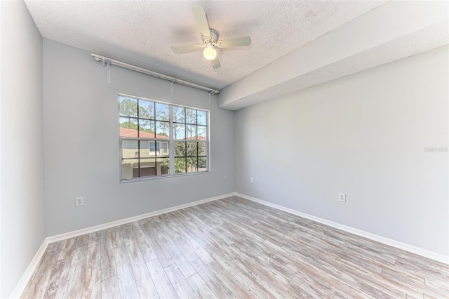 unfurnished room featuring ceiling fan, light hardwood / wood-style flooring, and a textured ceiling