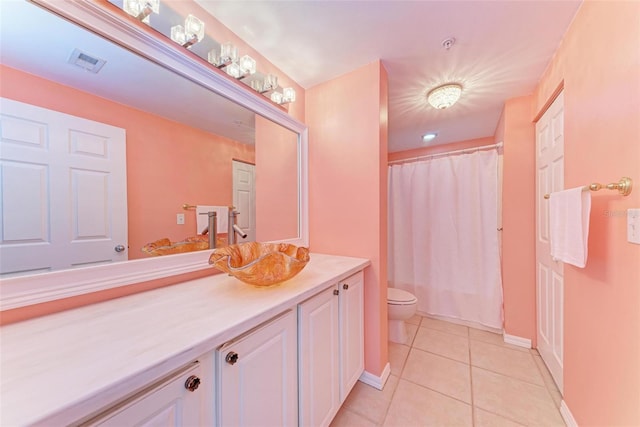 bathroom featuring vanity, toilet, and tile flooring