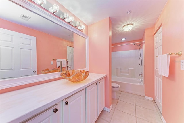 full bathroom featuring tiled shower / bath combo, tile floors, vanity, and toilet