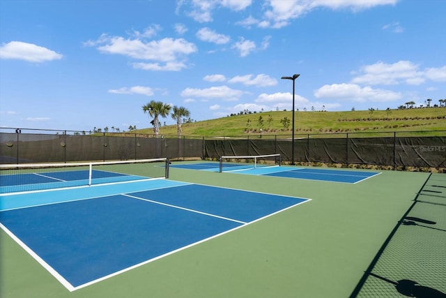 view of sport court with a rural view and basketball court