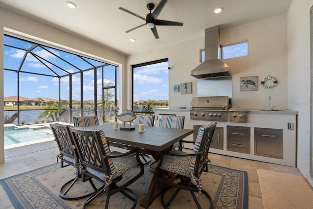 view of patio / terrace featuring a water view, sink, area for grilling, ceiling fan, and a grill