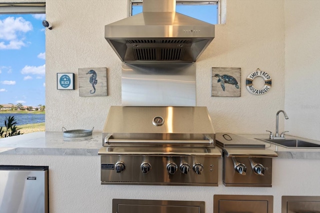 view of patio / terrace with a water view, grilling area, and sink