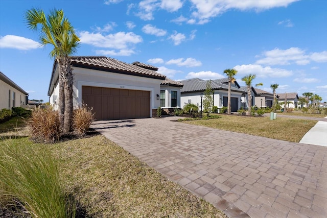 mediterranean / spanish-style house featuring a front lawn and a garage