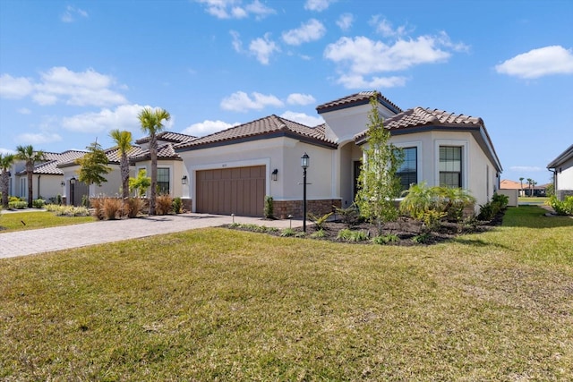 mediterranean / spanish-style home with a garage and a front lawn