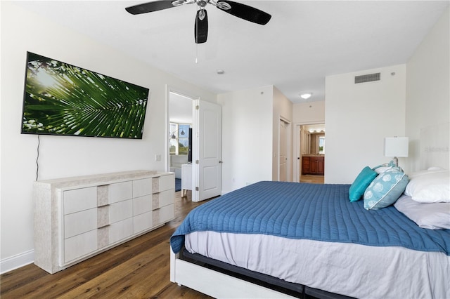 bedroom with connected bathroom, ceiling fan, and dark hardwood / wood-style floors