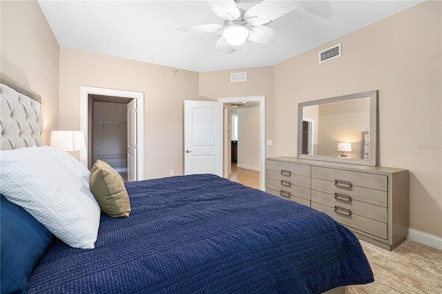 bedroom featuring a closet, a spacious closet, and ceiling fan