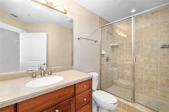 bathroom featuring an enclosed shower, toilet, and vanity