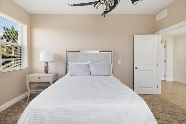 tiled bedroom with ceiling fan