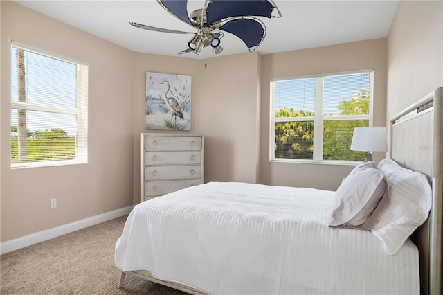 bedroom featuring ceiling fan, carpet, and multiple windows