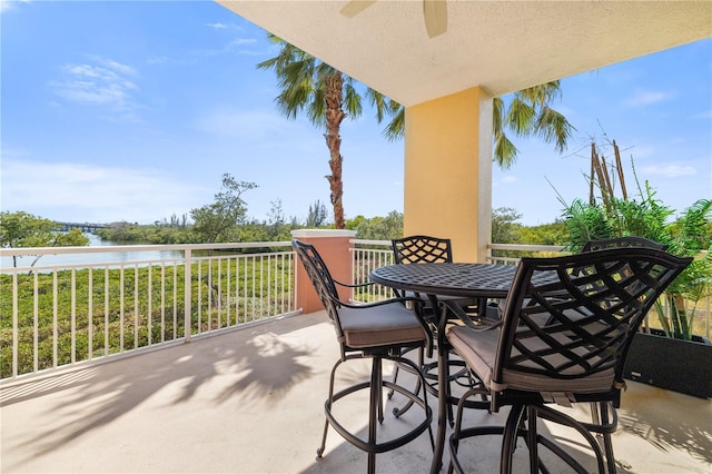 view of terrace with a balcony and a water view