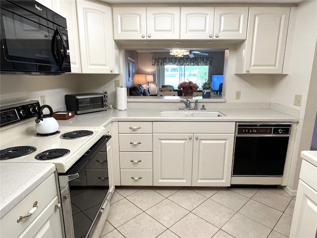 kitchen featuring black appliances, light countertops, and a sink