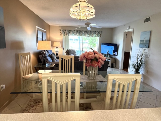 living area featuring baseboards, visible vents, a ceiling fan, and light tile patterned flooring