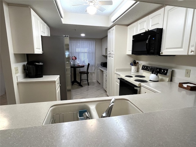 kitchen with white cabinets, electric stove, black microwave, a sink, and light tile patterned flooring