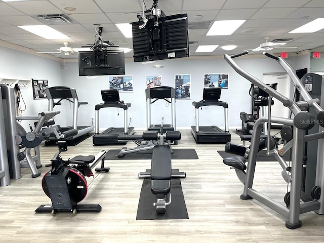 gym with a ceiling fan, visible vents, a drop ceiling, and wood finished floors