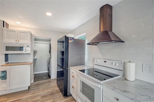 kitchen with white cabinets, white appliances, ventilation hood, a textured ceiling, and light hardwood / wood-style flooring