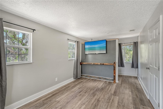 unfurnished bedroom featuring a textured ceiling and hardwood / wood-style flooring