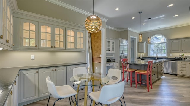 dining area featuring ornamental molding and light hardwood / wood-style floors