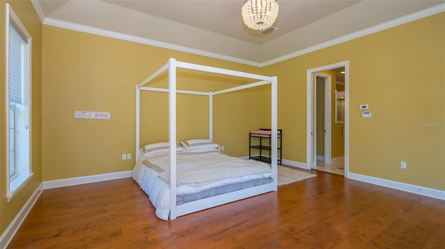 bedroom featuring wood-type flooring, crown molding, and an inviting chandelier