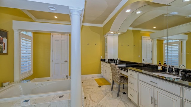 bathroom featuring tiled tub, decorative columns, vanity, tile floors, and ornamental molding