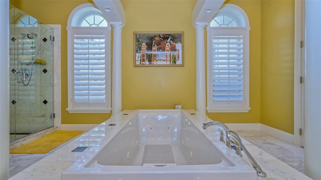 bathroom with tile flooring, independent shower and bath, and decorative columns