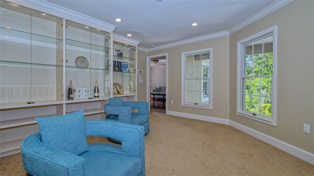 living area with carpet, crown molding, and a wealth of natural light