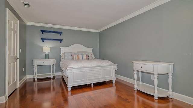 bedroom featuring crown molding and dark wood-type flooring