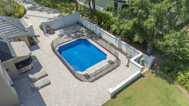 view of swimming pool with a lawn and a patio area