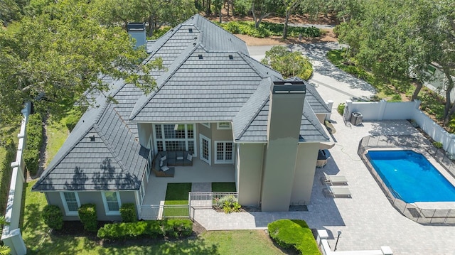 exterior space with a fenced in pool and a patio