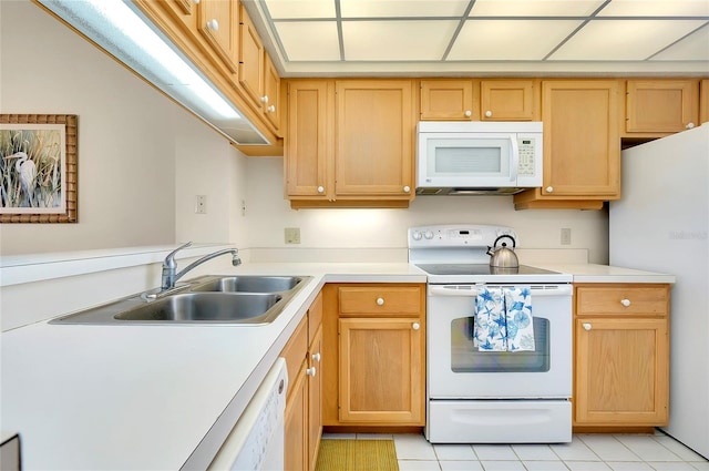 kitchen featuring sink, white appliances, and light tile floors