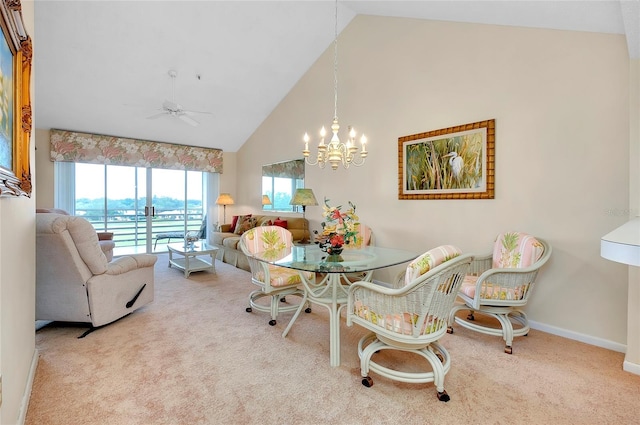 dining room featuring high vaulted ceiling, carpet floors, ceiling fan with notable chandelier, and a water view