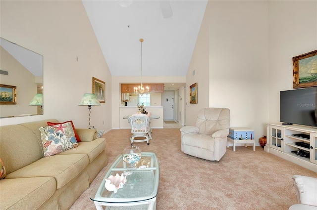 carpeted living room featuring high vaulted ceiling and an inviting chandelier