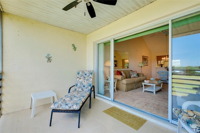 sunroom / solarium with ceiling fan with notable chandelier