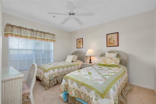 bedroom featuring ceiling fan and carpet