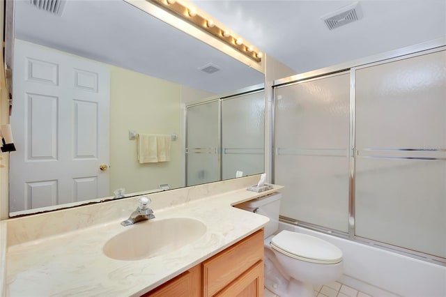 full bathroom with tile flooring, vanity, toilet, and shower / bath combination with glass door