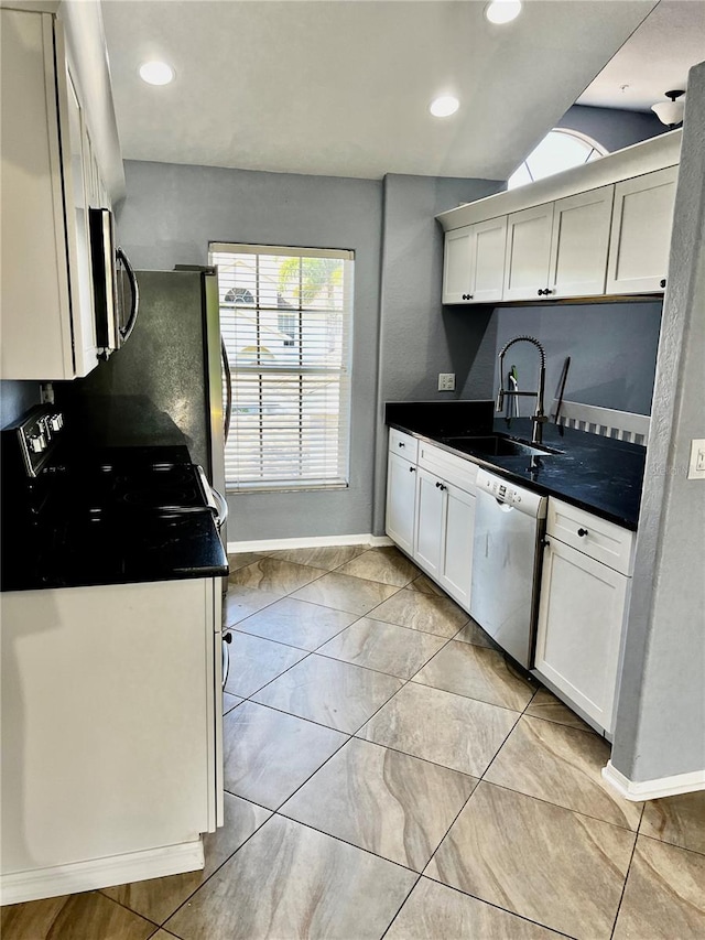 kitchen featuring white cabinetry, sink, lofted ceiling, and appliances with stainless steel finishes