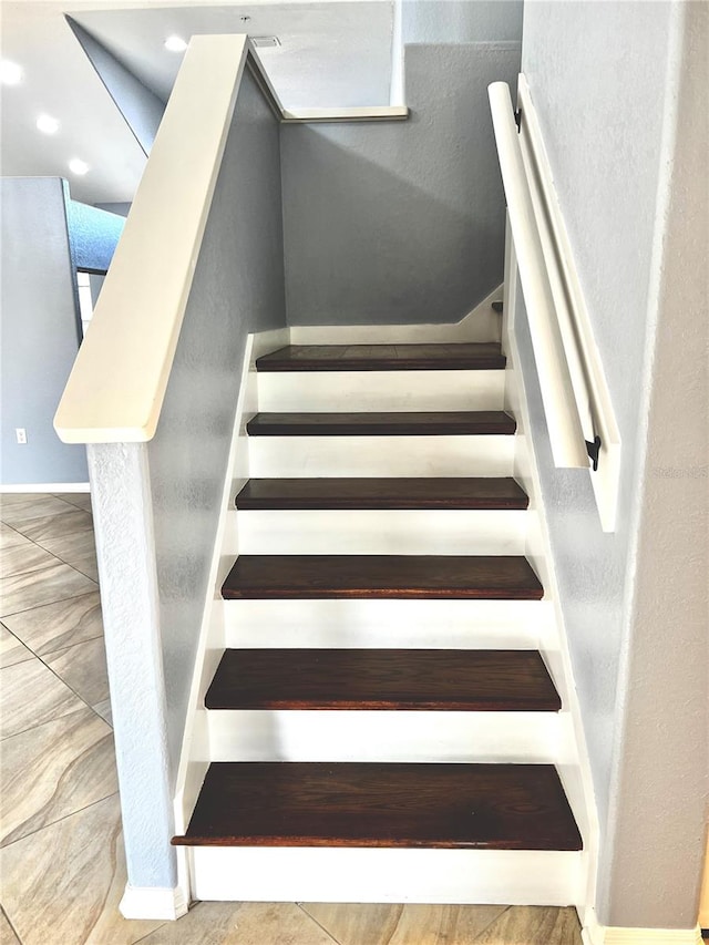 stairs featuring tile patterned floors