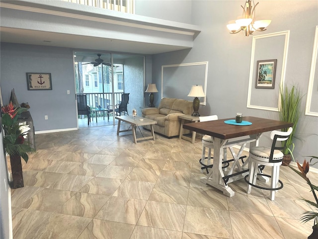 living room featuring ceiling fan with notable chandelier