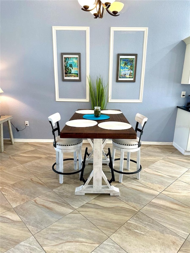 dining area with an inviting chandelier